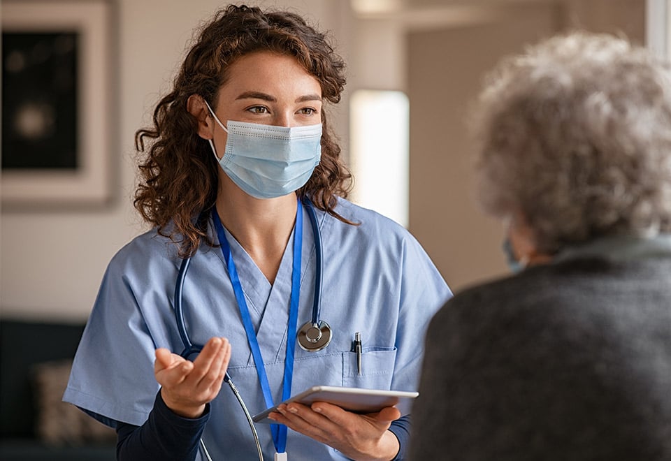 Nurse with Medical Mask On with Client 