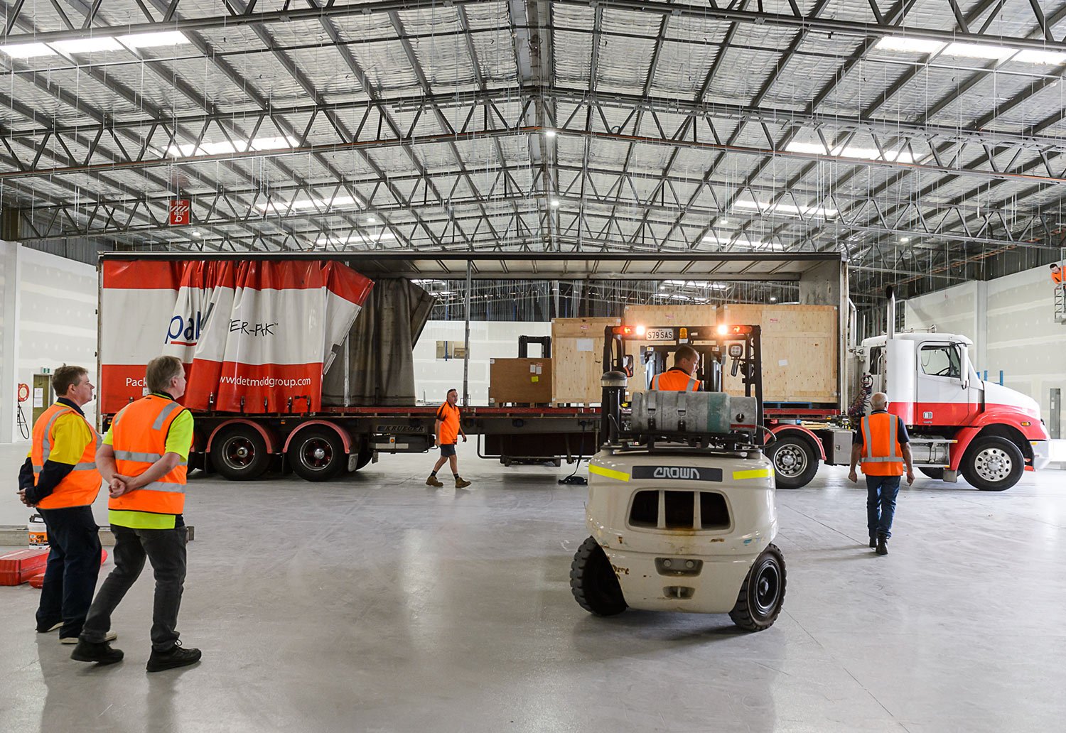 Image of truck being unloaded at new mask manufacturing facility in Brompton