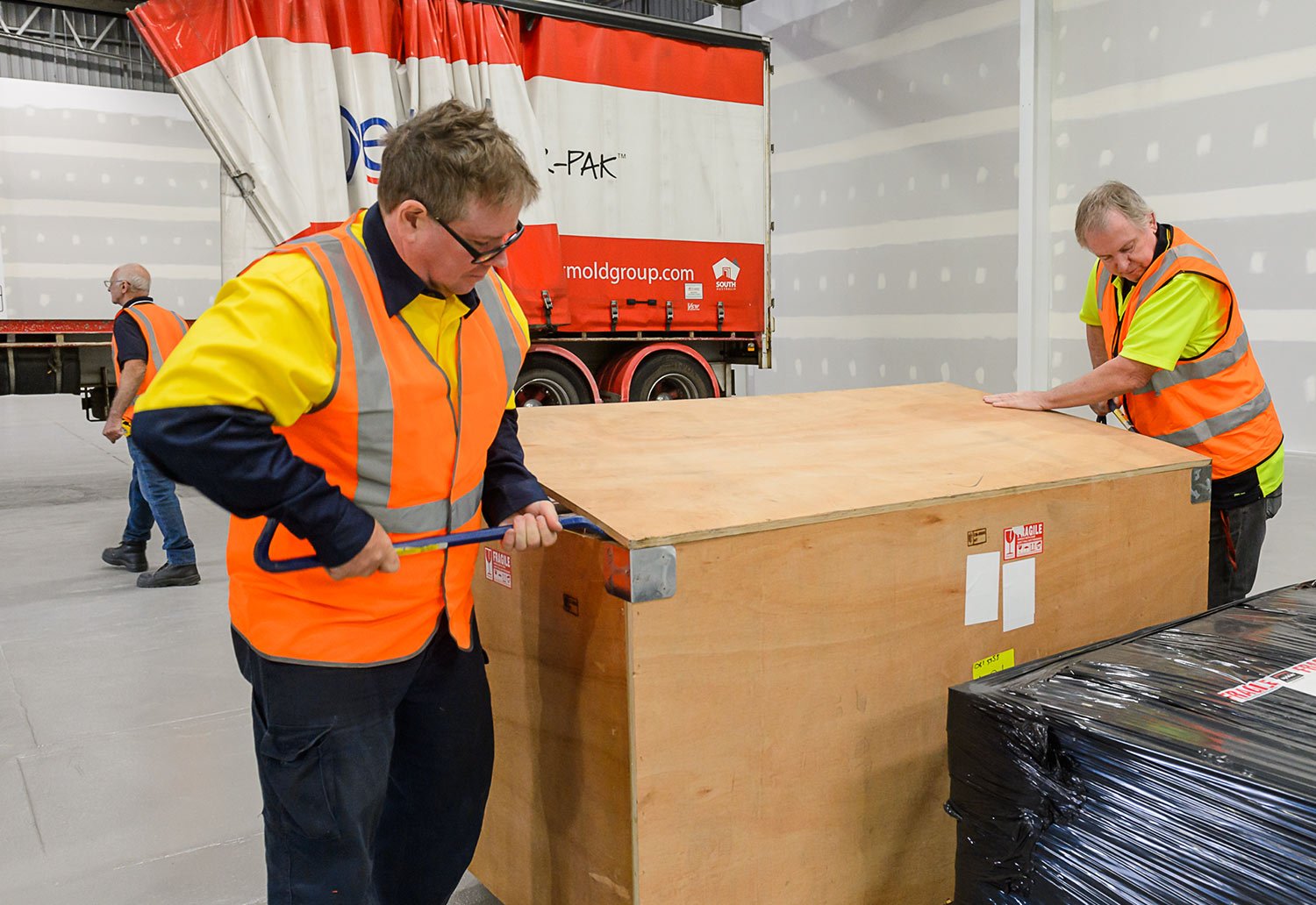 Crates of machinery unpacked at new mask manufacturing facility at Brompton